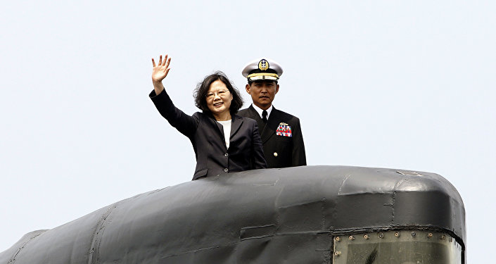 Taiwan's President Tsai Ing-wen, left, waves from a Zwaardvis-class submarine